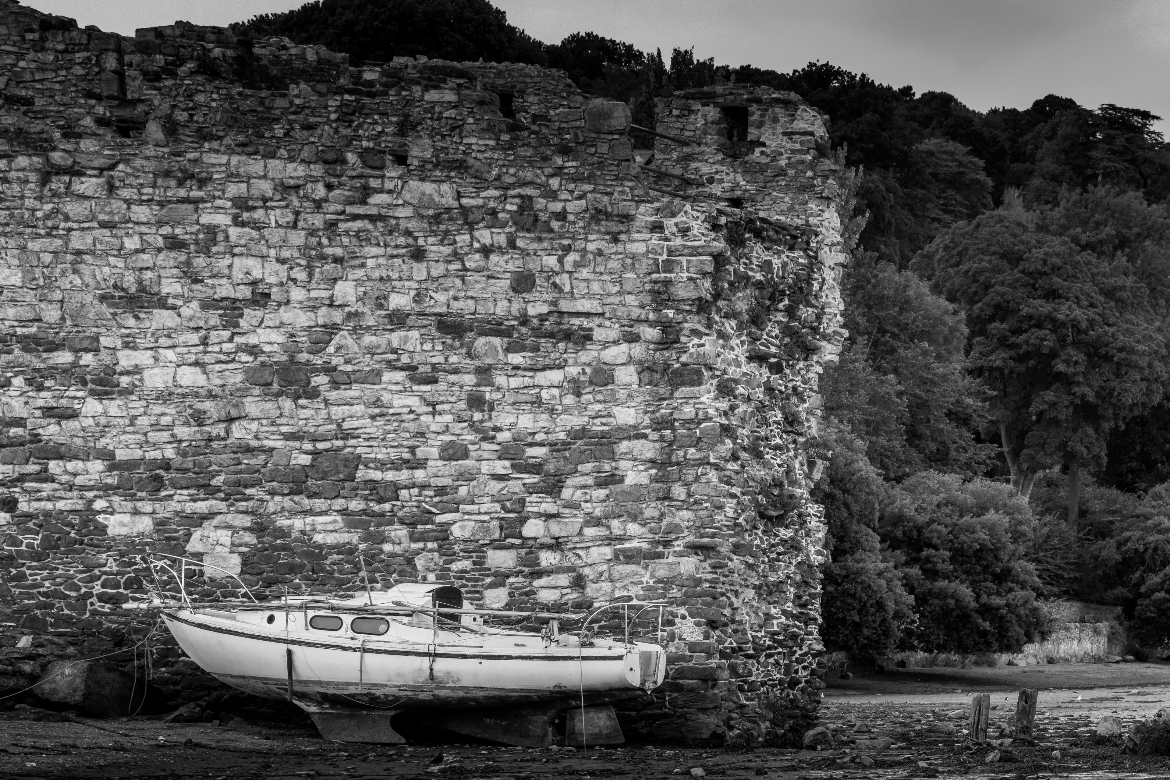 Boats resting against stone.