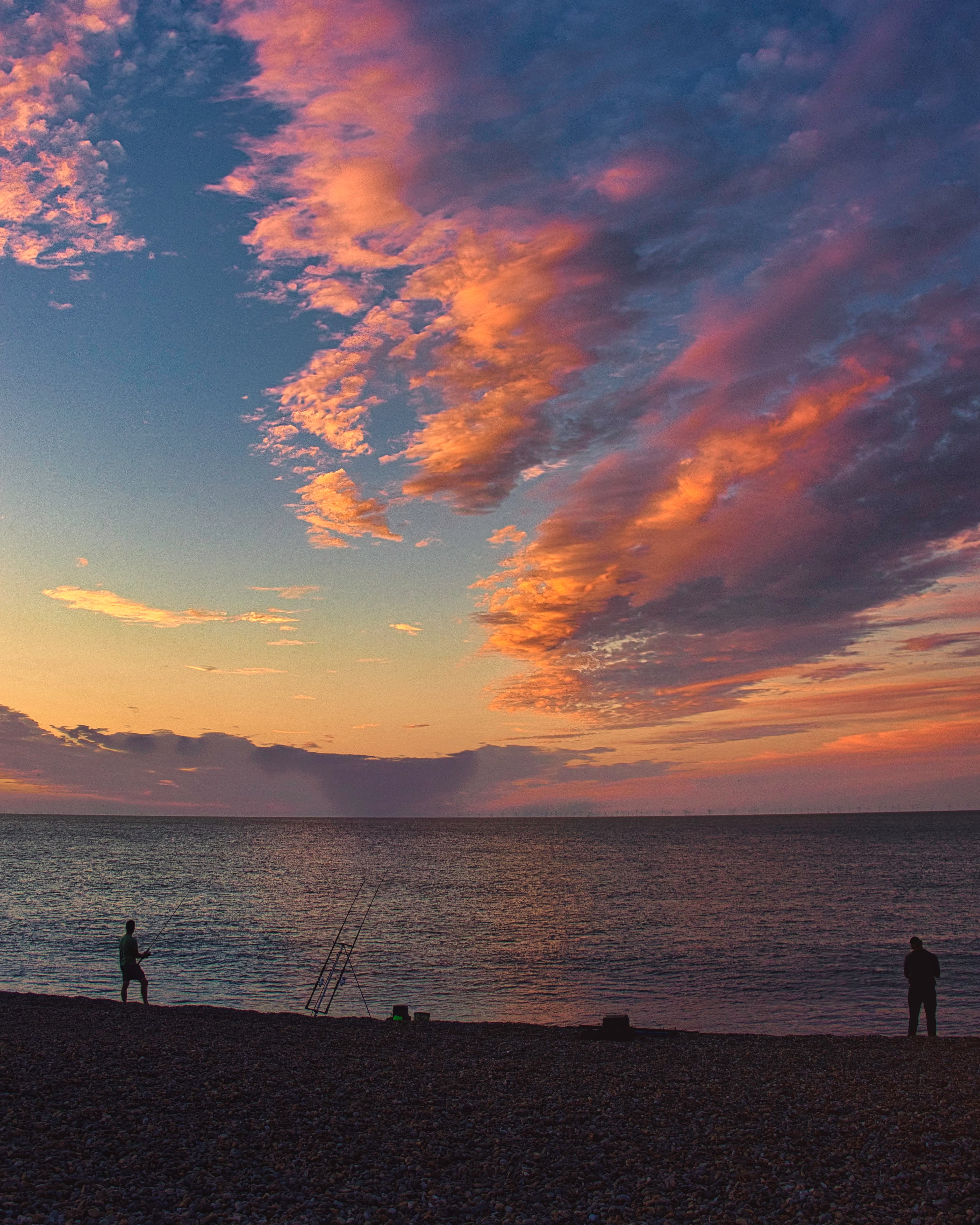 Two men on breakwater.