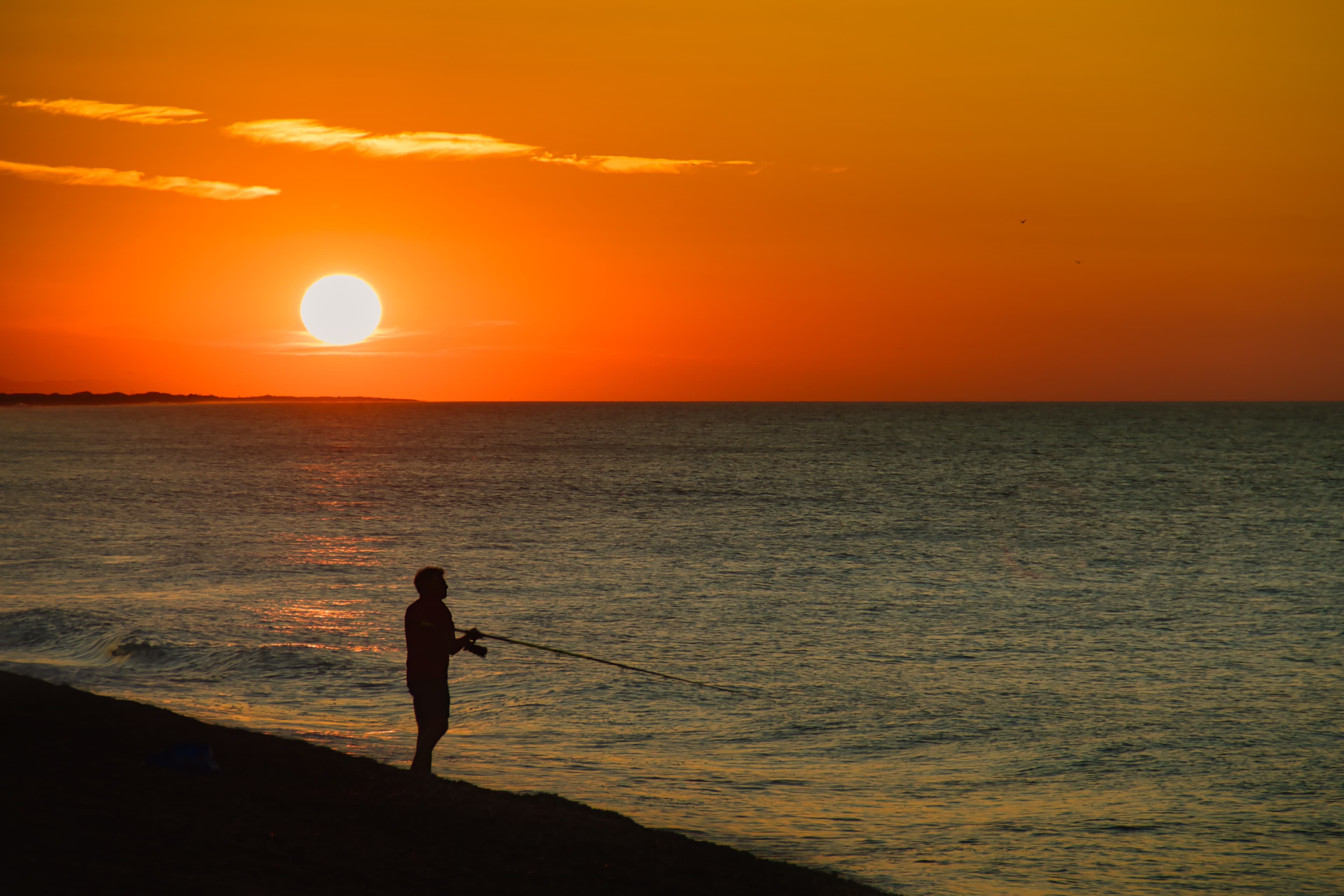 Lone figure on the shoreline.